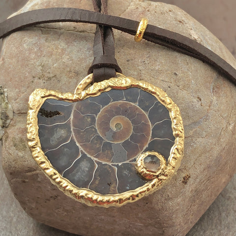 handmade fossiler ammonit schmuck anhänger aus madagaskar naturbelassen 22k vergoldet mit lederband fossiler schmuck stein anhänger ammonit naturstein schmuck von wonderworks 100 millionen jahre alt